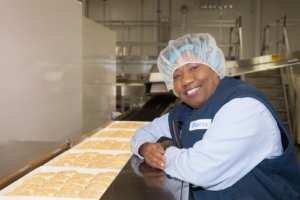 Bama team member smiling with biscuits